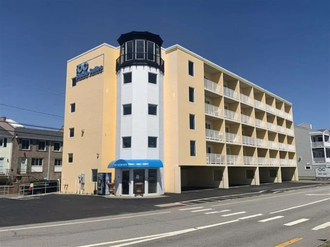 a yellow and white building with a blue awning.