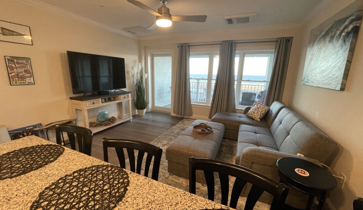 a living room filled with furniture and a flat screen tv.