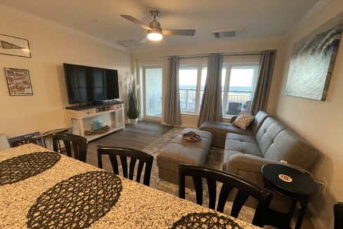 a living room filled with furniture and a flat screen tv.