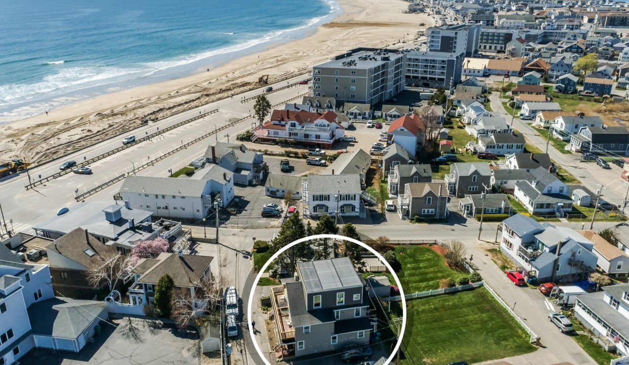 Aerial view of a coastal neighborhood with varied housing, highlighted by a circled house near the beach and roads lined with other residences.