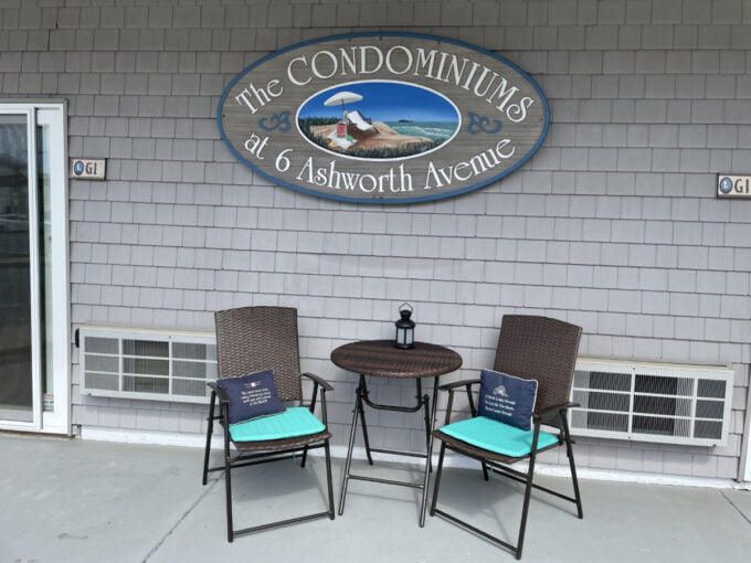 two chairs and a table outside of a building.