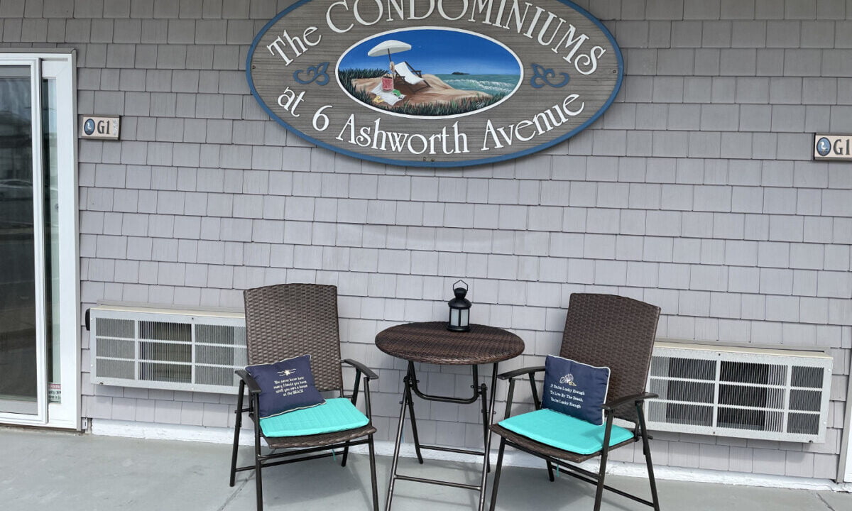 two chairs and a table outside of a building.