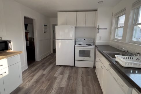 a kitchen with a sink, stove and microwave.