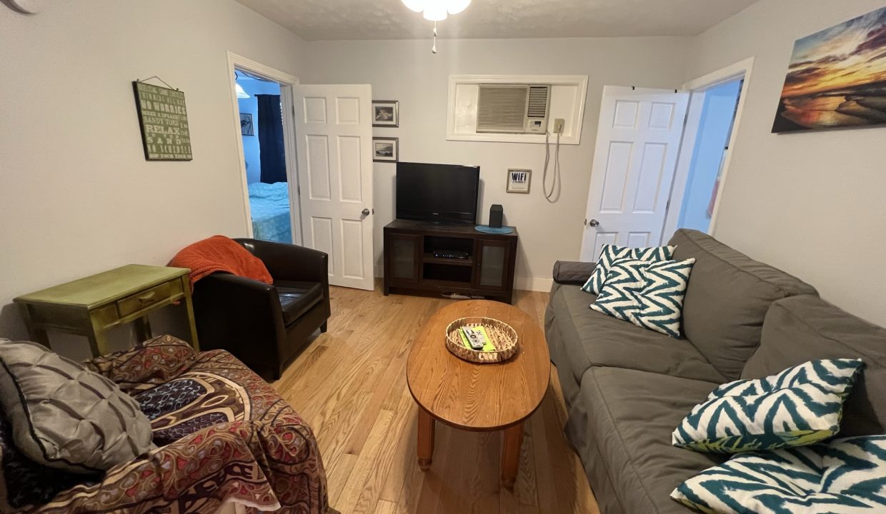 a living room filled with furniture and a flat screen tv.