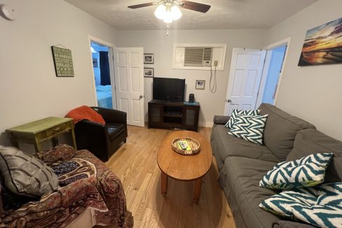 a living room filled with furniture and a flat screen tv.