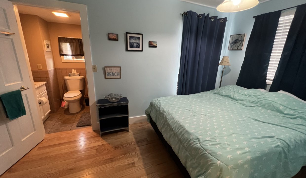 a bed sitting in a bedroom next to a doorway.