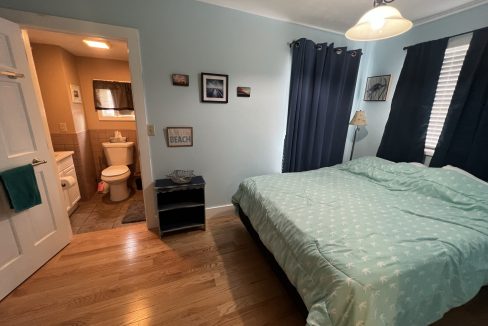 a bed sitting in a bedroom next to a doorway.