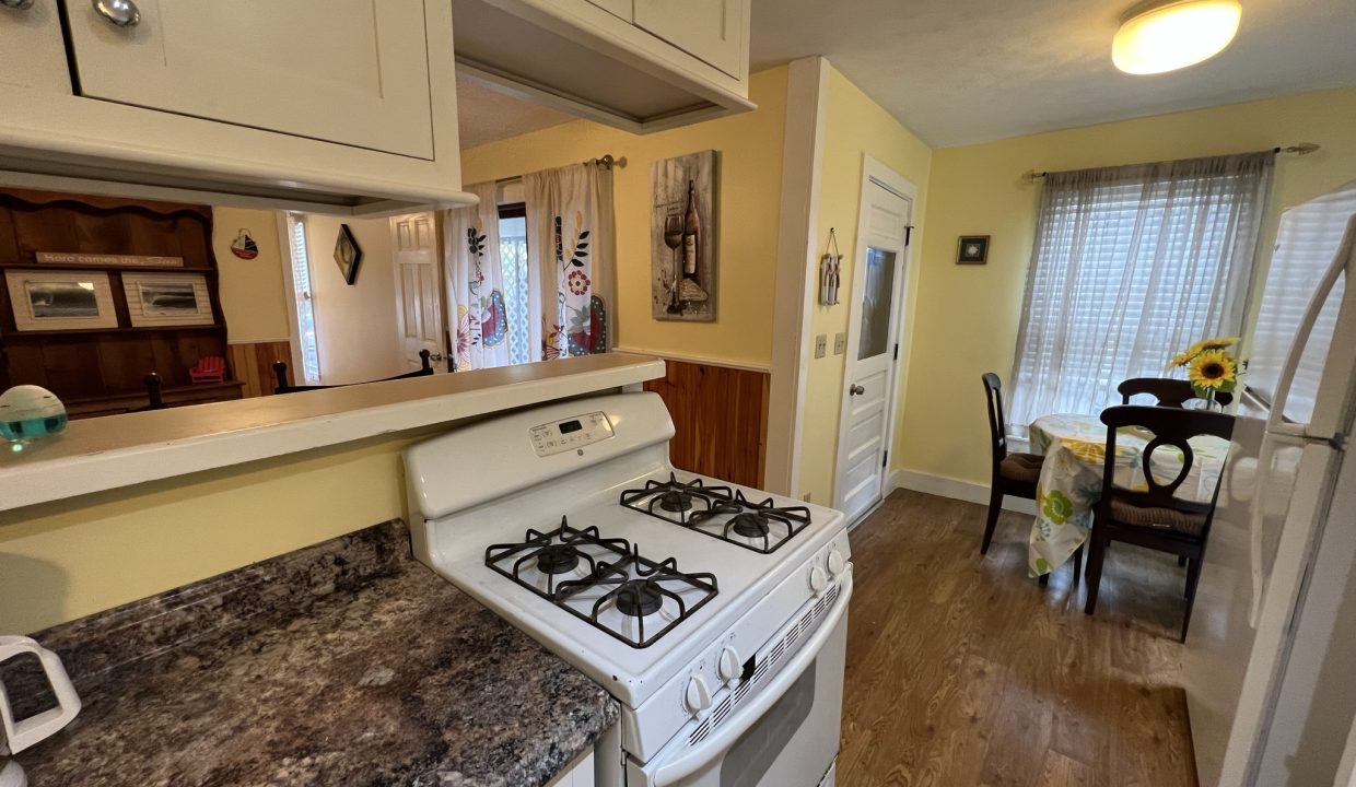 a white stove top oven sitting inside of a kitchen.