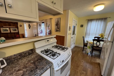 a white stove top oven sitting inside of a kitchen.