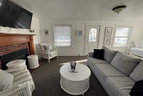 a living room filled with furniture and a fire place.