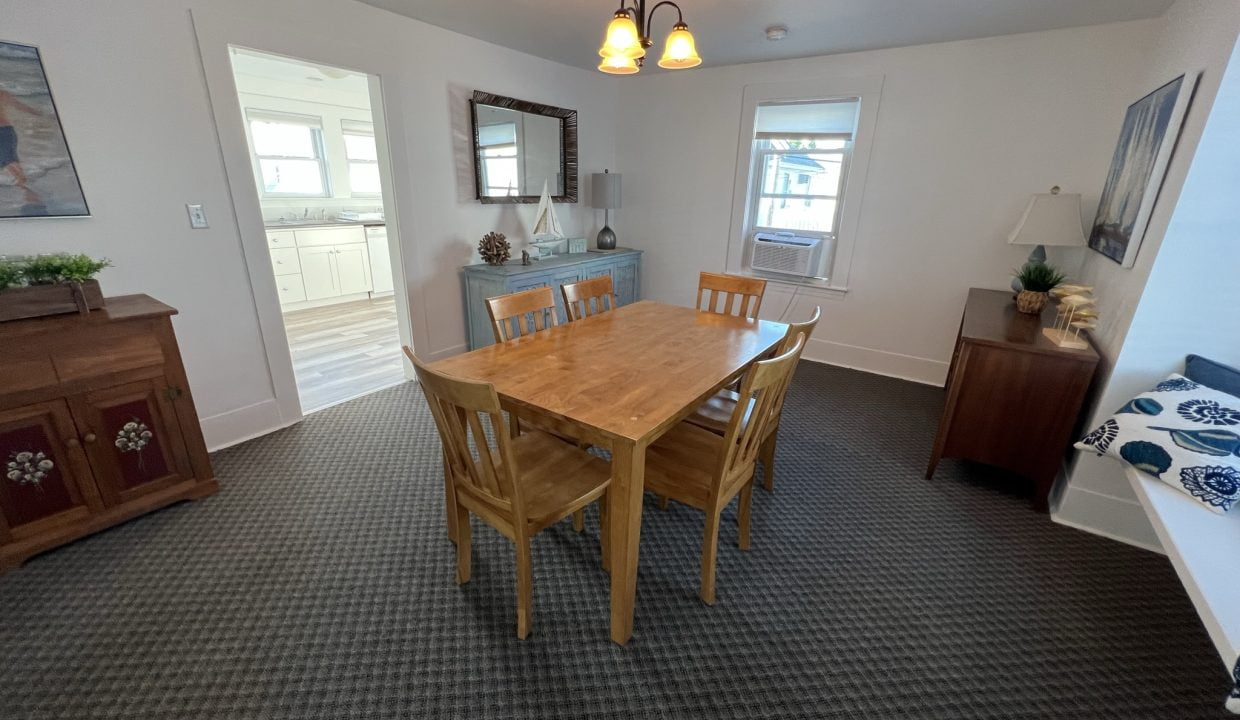 a dining room with a wooden table and chairs.