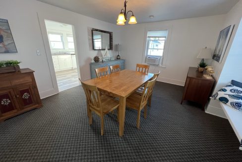 a dining room with a wooden table and chairs.