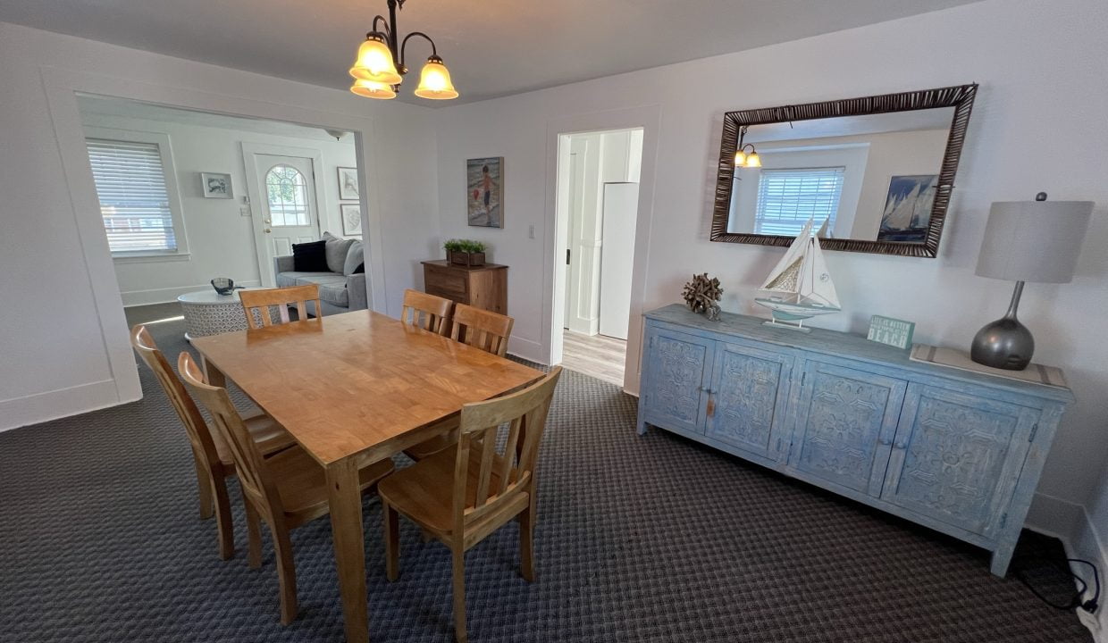 a dining room with a wooden table and chairs.