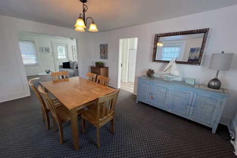 a dining room with a wooden table and chairs.