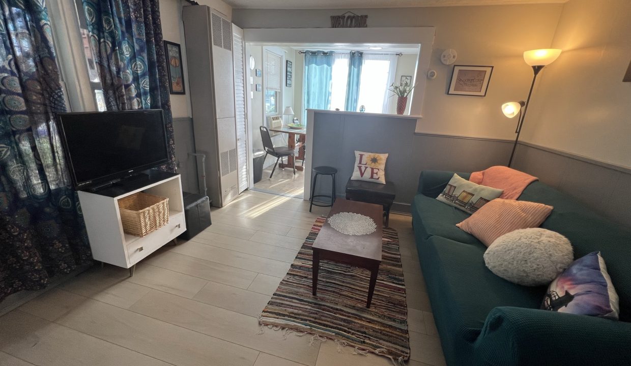 a living room filled with furniture and a flat screen tv.