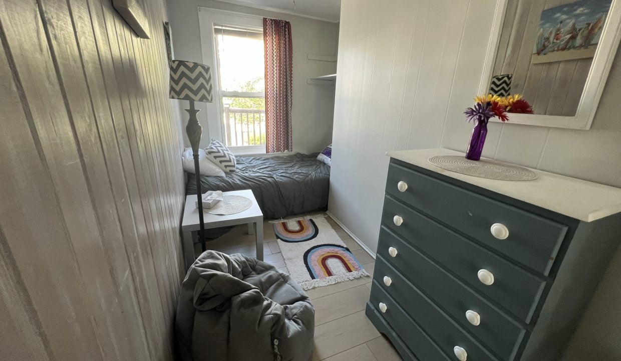 a bedroom with two beds and a dresser.