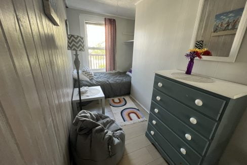 a bedroom with two beds and a dresser.