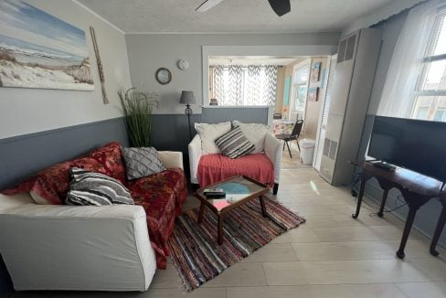 a living room filled with furniture and a flat screen tv.