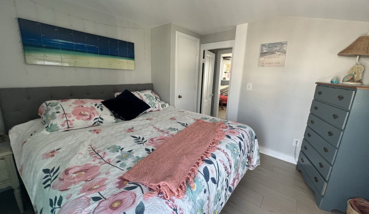 a bedroom with a large bed and a dresser.