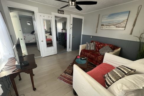 a living room filled with furniture and a flat screen tv.