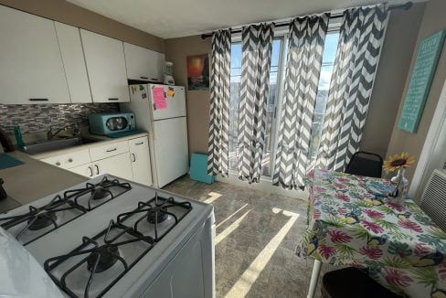 a kitchen with a stove top oven next to a window.