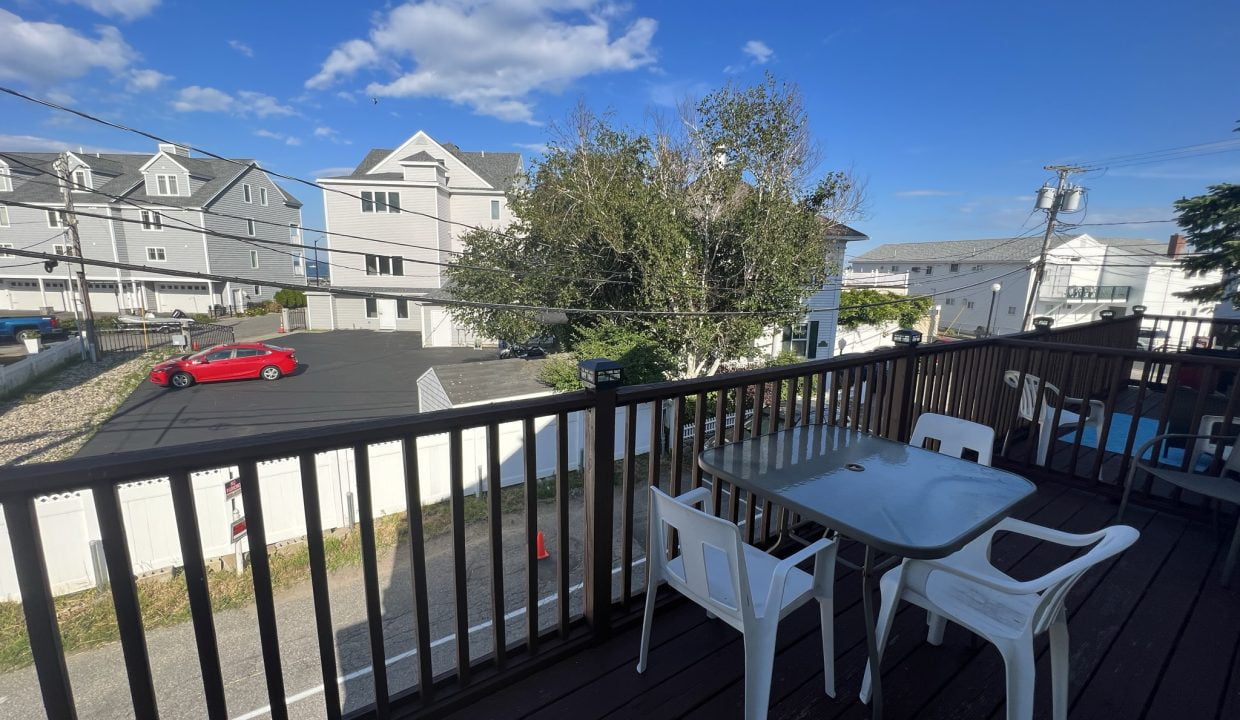 a balcony with a table and chairs on it.