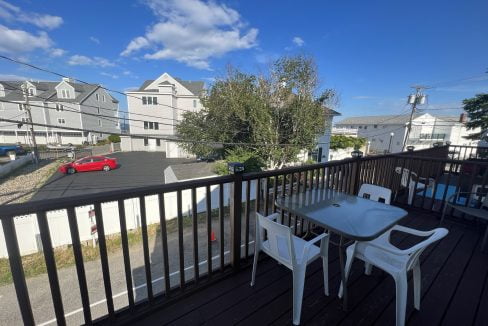 a balcony with a table and chairs on it.