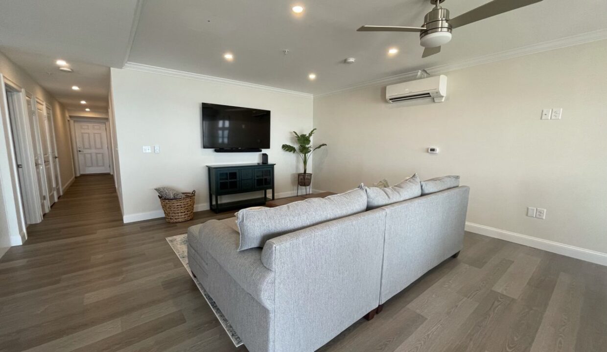 a living room filled with furniture and a flat screen tv.