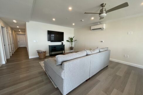 a living room filled with furniture and a flat screen tv.