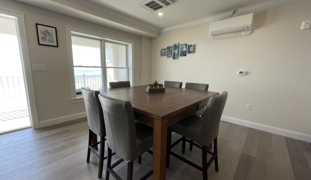 a dining room with a table and chairs.