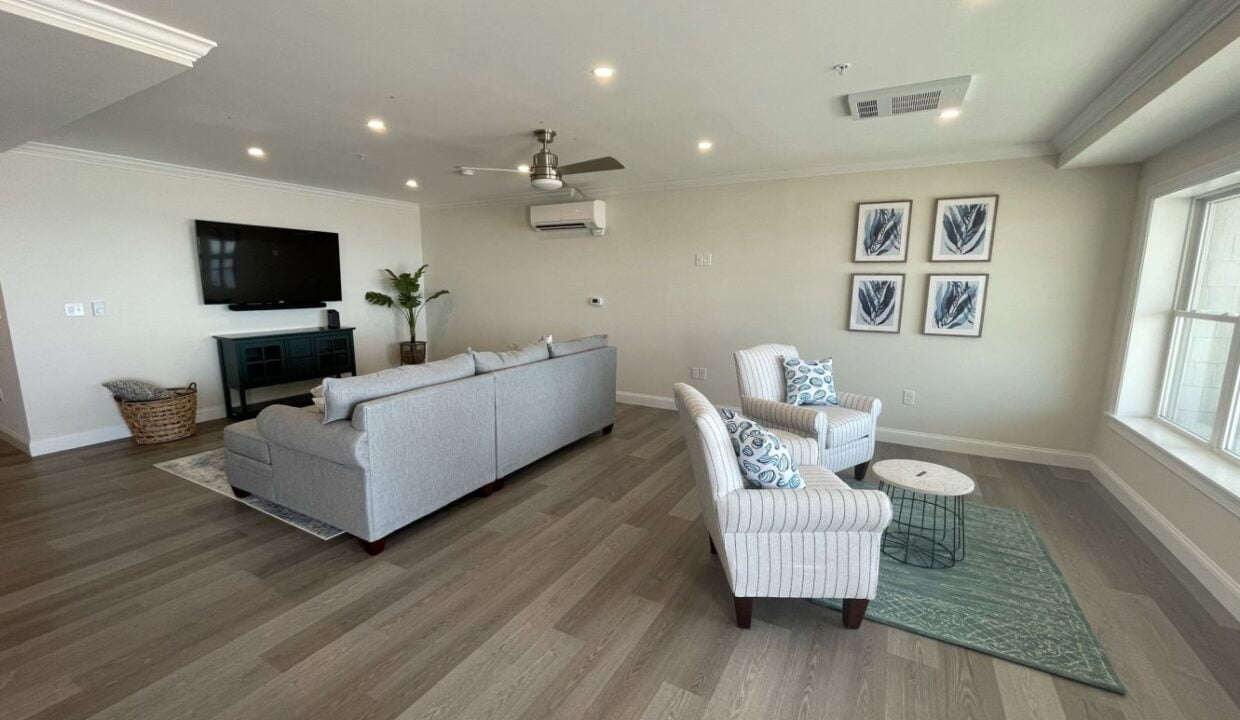 a living room filled with furniture and a flat screen tv.