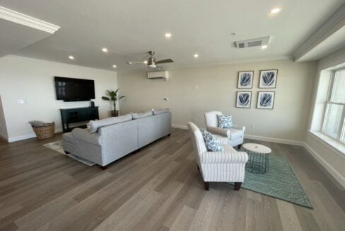 a living room filled with furniture and a flat screen tv.