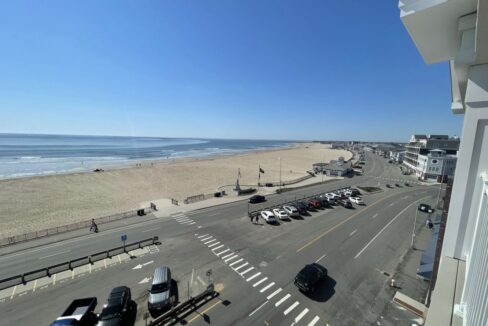 a view of a beach from a balcony of a building.