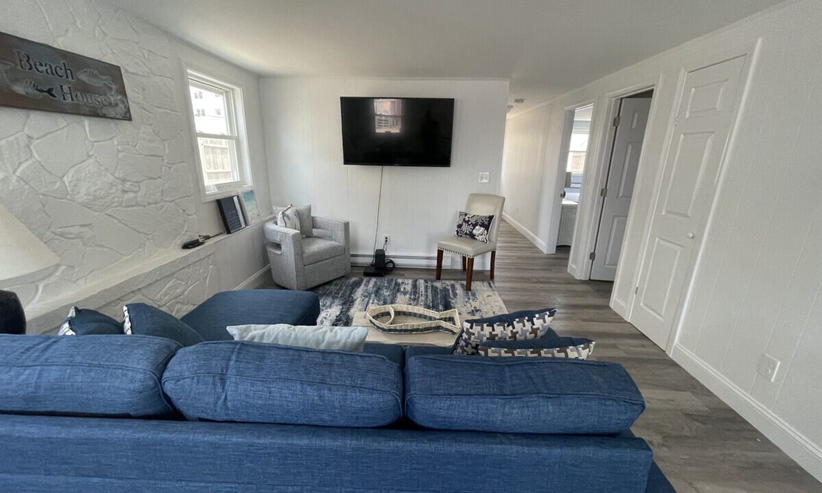 a living room filled with furniture and a flat screen tv.