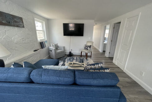 a living room filled with furniture and a flat screen tv.