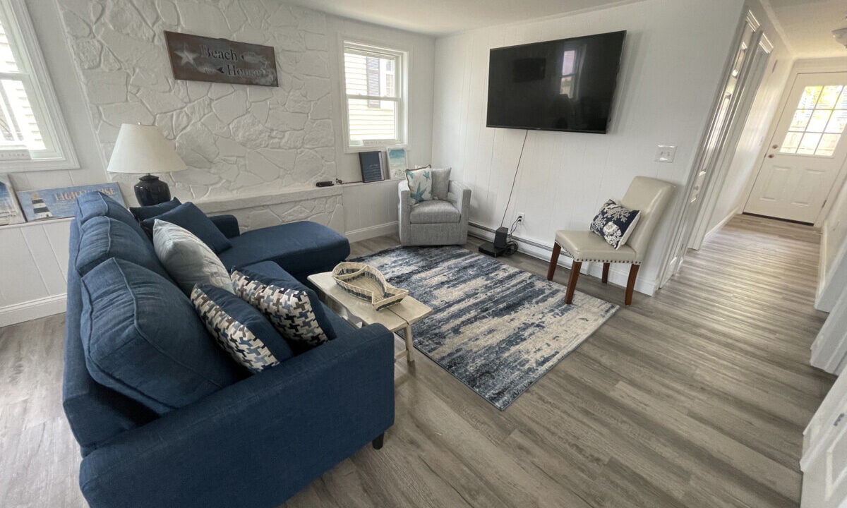 a living room filled with furniture and a flat screen tv.