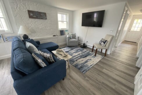 a living room filled with furniture and a flat screen tv.