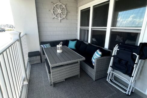 a balcony with a table and chairs on it.