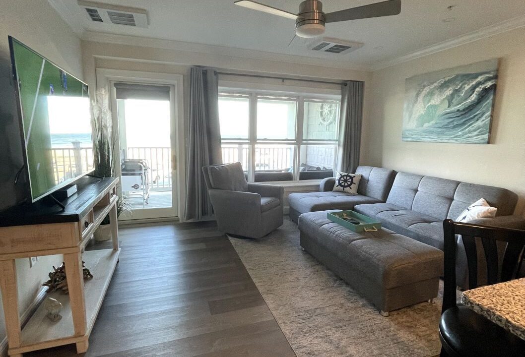 a living room filled with furniture and a flat screen tv.