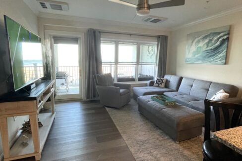 a living room filled with furniture and a flat screen tv.