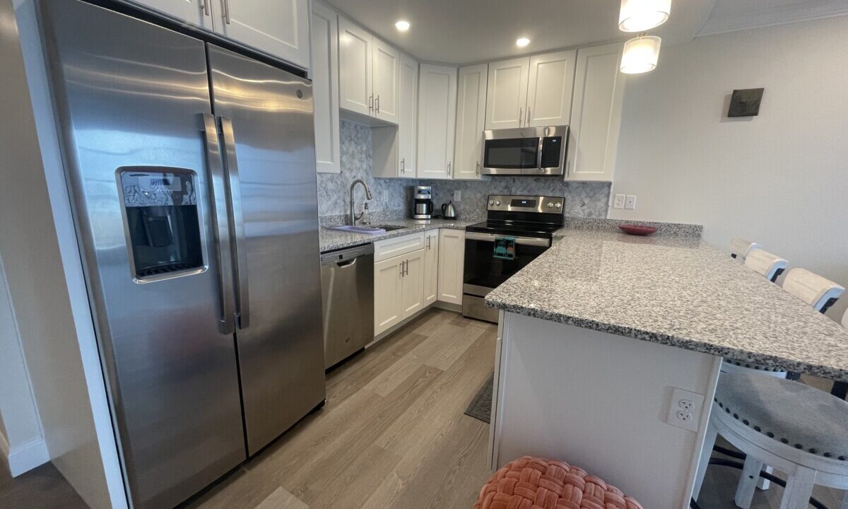 a kitchen with stainless steel appliances and white cabinets.