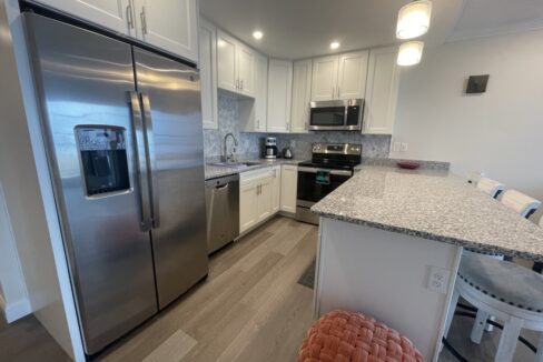 a kitchen with stainless steel appliances and white cabinets.