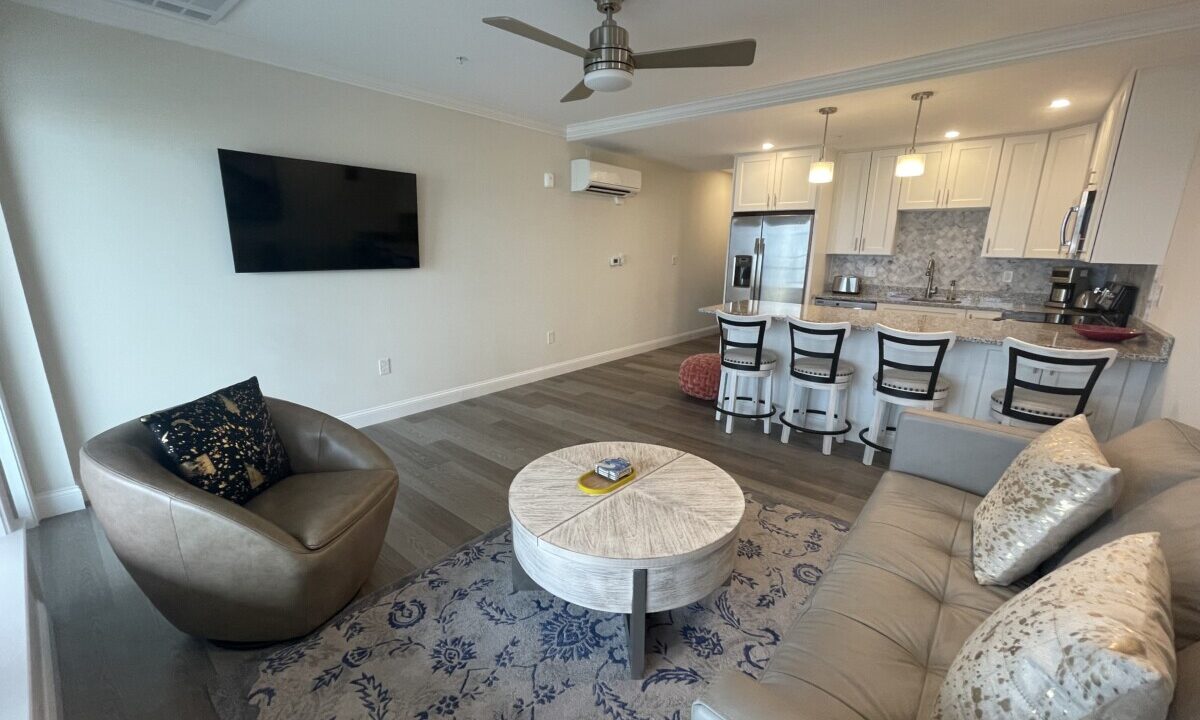 a living room filled with furniture and a flat screen tv.