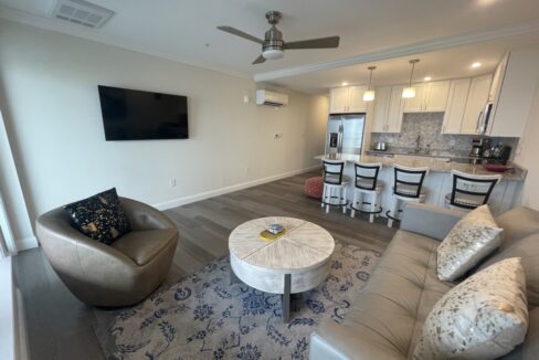 a living room filled with furniture and a flat screen tv.