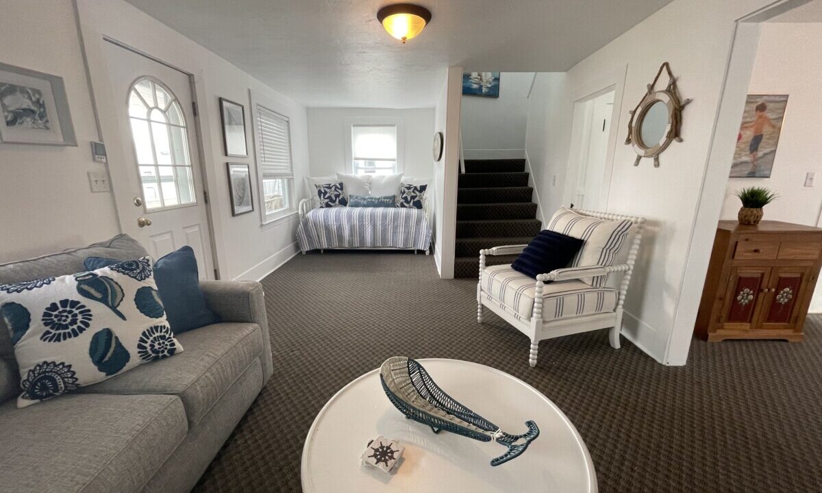 a living room filled with furniture and a white table.