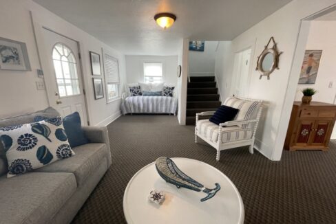 a living room filled with furniture and a white table.