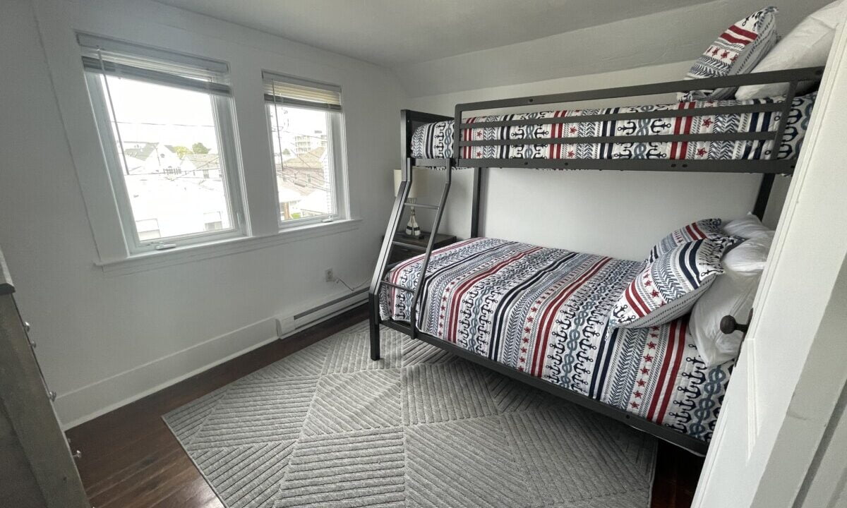 a bedroom with a bunk bed and a window.