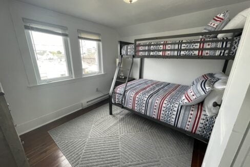 a bedroom with a bunk bed and a window.