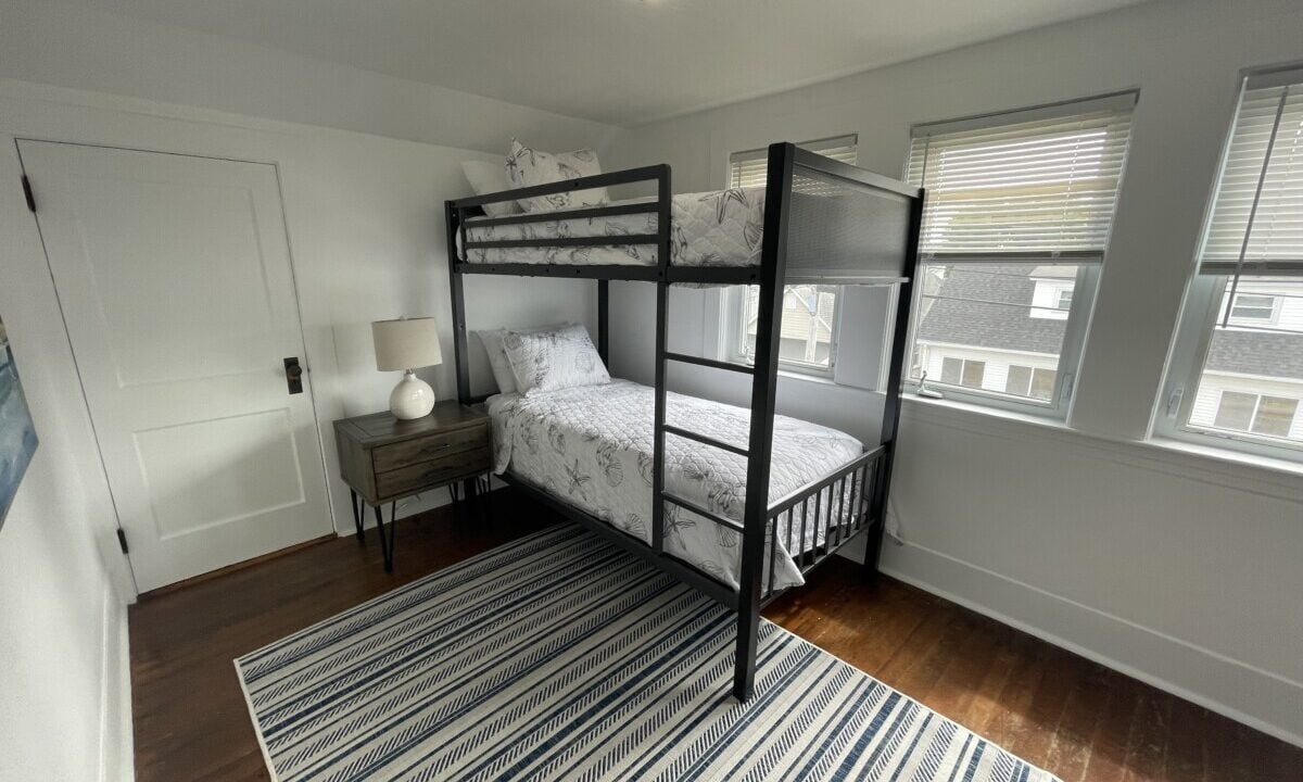 a bedroom with a bunk bed and a rug.