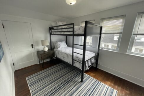 a bedroom with a bunk bed and a rug.